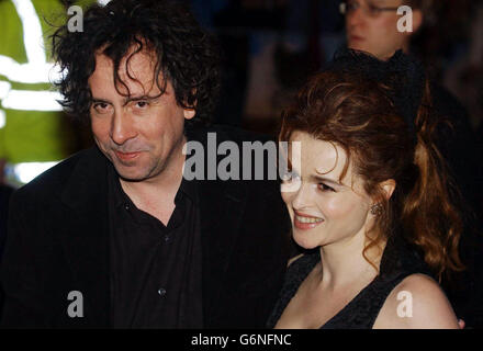 Director Tim Burton with his partner Helena Bonham Carter arrive at the UK gala celebrity premiere of his latest film Big Fish, at the Warner Village, Leicester Square, central London. Stock Photo
