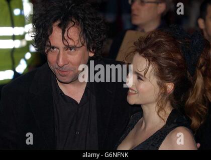 Director Tim Burton with his partner actress Helena Bonham Carter arrive at the UK gala celebrity premiere of his latest film Big Fish, at the Warner Village, Leicester Square, central London. Stock Photo
