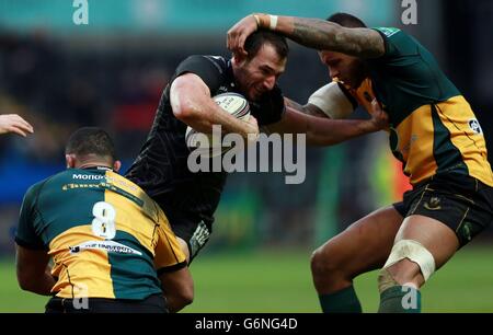 Ospreys Joe Bearman is tackled by Northampton's Courtney Lawes and Samu Manoa during the Heineken Cup, Pool One match at the Liberty Stadium, Swansea. Stock Photo