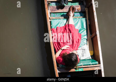 A woman in a red dress in a punt on the River Cam Cambridge UK Stock Photo