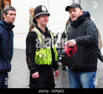 A police officer talks with a member of the public in Birmingham city centre. Stock Photo