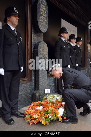 The Metropolitan Police Commissioner Sir Bernard Hogan-Howe lays a wreath at the memorial service at the Harrods Bombing memorial, on the 30th anniversary of the terrorist attack which left three Police Officers and three members of the public dead, on December 17, 1983, outside the landmark department store in west London. Stock Photo