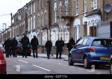 Police officers searching the scene on Ruskin Road in Tottenham, north London, after two 16-year-olds were injured, one critically, after being stabbed during a fight in the early hours of the morning. Stock Photo