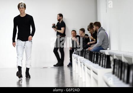 A model appears on the catwalk during a rehearsal for the Lou Dalton show at British Fashion Council's London Collections: Men fashion event, Victoria House, London. Stock Photo