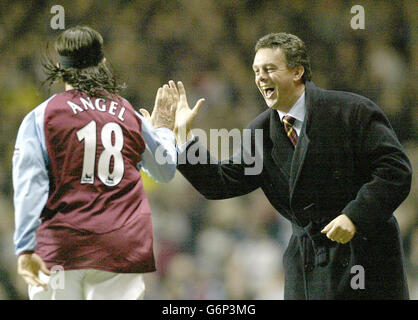 Aston Villa Manager David O'Leary celebrates the opening goal against visitors Portsmouth with scorer Juan Pablo Angel, during their Barclaycard Premiership match at Villa Park, Birmingham. Stock Photo