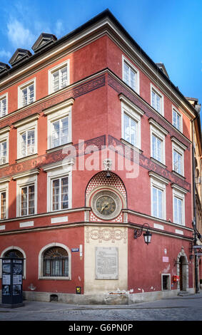 Street Corner Clock and memorial in Warsaw Old Town Stock Photo