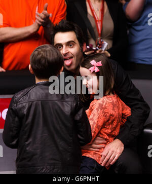 Ronnie O'Sullivan celebrates with his children Ronnie jnr (left) and Lily after defeating Mark Selby in the final during the 2014 Dafabet Masters at Alexandra Palace, London. Stock Photo