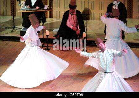 The Whirling Dervishes of Turkey performing with the Suleyman Erguner Ensemble, at the National Concert Hall in Dublin, Ireland. The Whirling Dervishes trace their origin back to the 13th century Sufi mystic and poet Rumi and the Mevlevi Order he founded in Konya, Turkey. The elements of music, poetry and whirling are ritualised by Sufi priests in a meditation on Divine Love. The performance moves to London's Queen Elizabeth Hall from 7th-8th February and then on to Edinburgh's Queens Hall on 10th February. Stock Photo