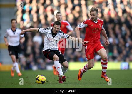 Fulham's Sascha Riether (left) and Southampton's Luke Shaw battles for possession of the ball during the Barclays Premier League match at Craven Cottage, London. Stock Photo