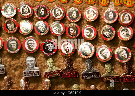 Manchester United badges on sale bearing the faces of club legends outside Old Trafford Stock Photo