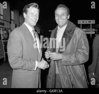 Singer Harry Belafonte (right) seen off by Roger Moore, 'The Saint' of the TV series, when he left London Airport for business discussions with a french group. Roger is a member of a committee which is to arrange entertainment for three big european rallies to be held by Dr. Martin Luther King, the American civil rights leader. Stock Photo
