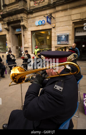 UK, Gloucestershire, Gloucester, Eastgate Street, Salvation Army band outside Guildhall at Christmas, trombone player Stock Photo