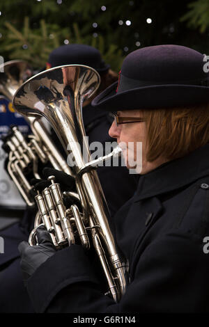 UK, Gloucestershire, Gloucester, Eastgate Street, Salvation Army band playing outside at Christmas, female horn player Stock Photo