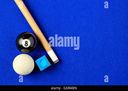 Billiard balls, cue and chalk on a blue pool table. Viewed from above. Horizontal image. Stock Photo