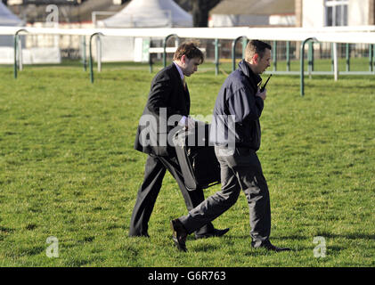 Jockey Tom Scudamore carrying his case across the track at Doncaster racecourse where he arrived by helicopter. Scudamore was riding Centasia for his trainer Martin Pipe in the opening race the Sky Bet Best Odds Guaranteed Hurdle before dashing back by helicopter to Cheltenham where he had other rides for David Pipe. Stock Photo