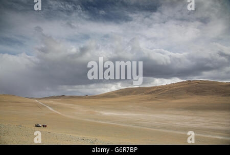 Higway to West with two cars parked on the side of a road Stock Photo