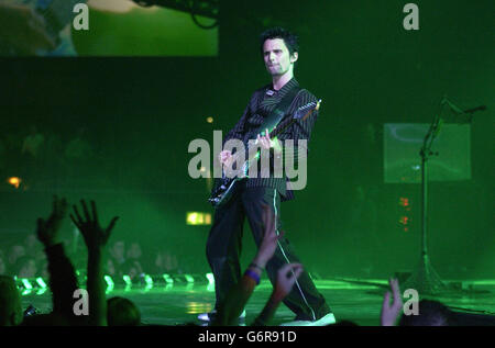 Rock band Muse performing on stage at the annual Brit Awards 2004 at Earls Court in south west London. Stock Photo
