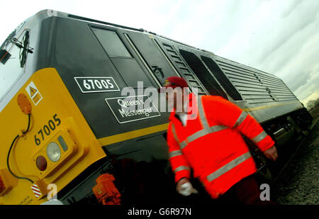 Paint technician Byrn Davis checks the finish on the Class 67 locomotive 'Queen's Messenger' which will pull the Royal Train in future, and which was unveiled, at the EWS (English, Welsh & Scottish Railway) deport at Toton, near Nottingham. The 90 tonne locomotive will replace two diesel engines - named Prince William and Prince Harry - which have pulled the train since 1995. The first Royal Train ran on 13 June 1842, transporting Queen Victoria from Slough to Paddington on a journey taking 25 minutes. Stock Photo