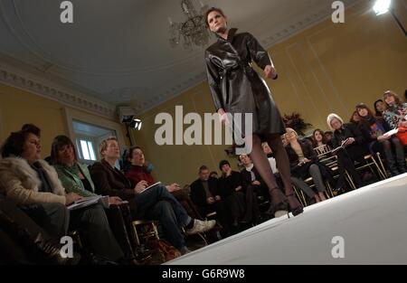 Reporter Karen Price (right of model) attends the Jean Muir fashion show during London Fashion Week. Suzy Menkes and Hilary Alexander (on left) are also in attendance . Stock Photo