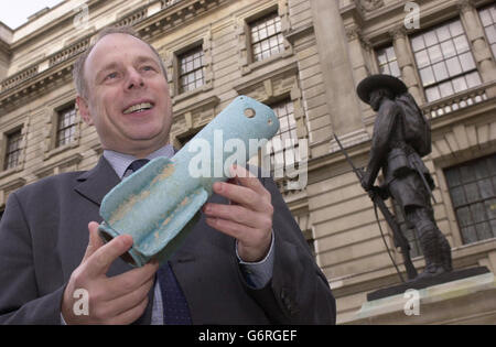 Conservative MP Ian Liddell- Grainger holds aloft one of two missile-casings found washed ashore on the Weston-Super-Mare coastline, outside the Old War Office in central London. Mr Liddell-Grainger, who was returning the blue fibre-glass tail-fins to the MoD, today accused the ministry of a 'catalogue of failures' in allowing a pallet load of missiles to be lost during a routine underwater disposal exercise which went wrong in March 2002.