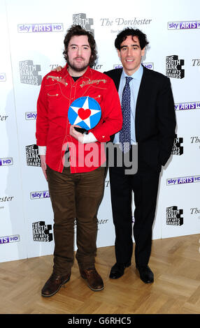 Nick Helm wins the Times Breakthrough award, presented by Stephen Mangan, at the South Bank Sky Arts Awards at the Dorchester Hotel, London. Stock Photo