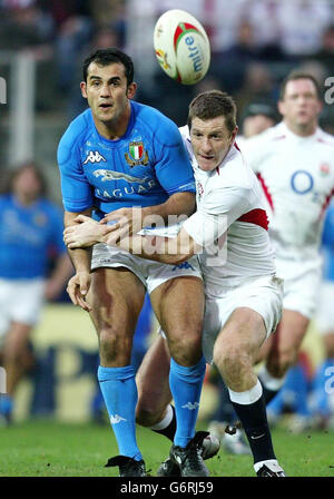 Italy's Cristian Stoica (left) is tackled by Will Greenwood of England during their RBS 6 Nations match at the Stadio Flaminio in Rome, Italy. England defeated Italy. Stock Photo