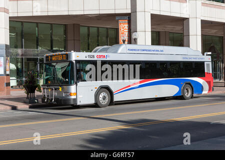A compressed natural gas (CNG) powered COTA bus waits to load passengers on S High Street in Columbus, Ohio. Stock Photo