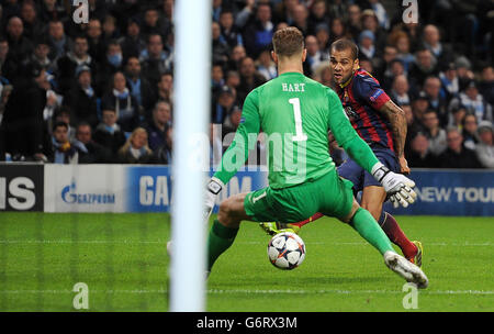 FC Barcelona's Daniel Alves scores his teams 2nd goal past Manchester City's Joe Hart during the UEFA Champions League, Round of 16 match at the Etihad Stadium, Manchester. Stock Photo