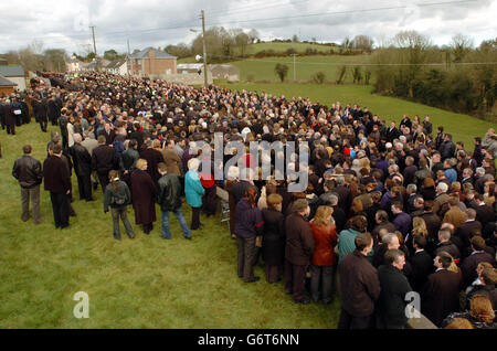 Mourners flock from all corners of Ireland to the tiny village of Eglish, Co Tyrone, Northern Ireland, for the funeral of local hero and Tyrone GAA football captain, Cormac McAnallen. Gaelic football's bright young star died suddenly of a heart infection last week. Stock Photo