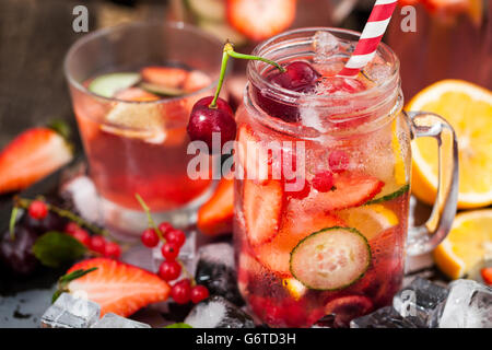 Healthy infused detox water with fresh berries and fruits in mason jar Stock Photo