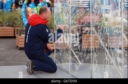 Team GB chef de mission Mike Hay signs the welcome wall on behalf of the athletes during the Team GB Welcome ceremony during the 2014 Sochi Olympic Games in Krasnaya Polyana, Russia. Stock Photo