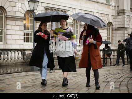 Visitors in the rain at BFC Courtyard Show Space, Somerset House in central London. Stock Photo