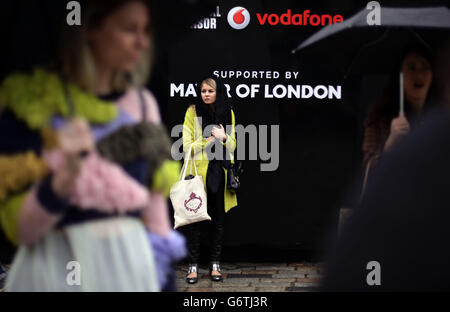 Visitors in the rain at BFC Courtyard Show Space, Somerset House in central London. Stock Photo