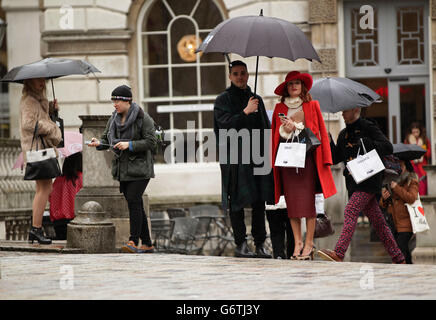 Visitors in the rain at BFC Courtyard Show Space, Somerset House in central London. Stock Photo