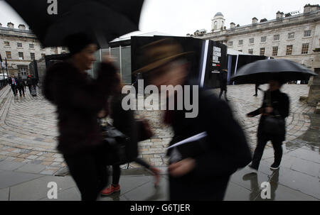 Visitors to London Fashion Week pass in front of the BFC Showspace at Somerset House on day one of London Fashion Week. Stock Photo