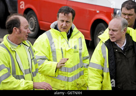 Prime Minister David Cameron (centre) arrives at a pumping operation on the Somerset Levels near Othery, Bridgwater, during a visit to see the extent of the flooding in the UK, as he announced that the Treasury will cover the cost of council tax rebates for flooding victims in England and warned that recovering from the crisis would be a 'very long haul'.