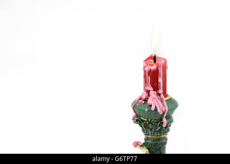 Bruning red aroma candle, with wax on cupid holder, isolated white background
