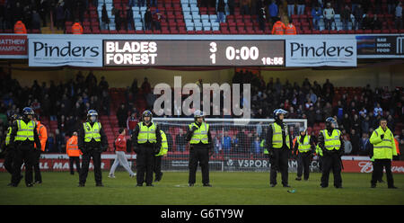 Soccer - FA Cup - Fifth Round - Sheffield United v Nottingham Forest - Bramall Lane. Police form a line on the pitch to stop supporters confronting each other after the FA Cup, Fifth Round match at Bramall Lane, Sheffield. Stock Photo