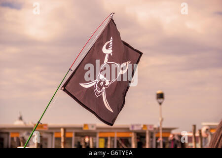 Pirate flags in the wind on a blue sky Stock Photo