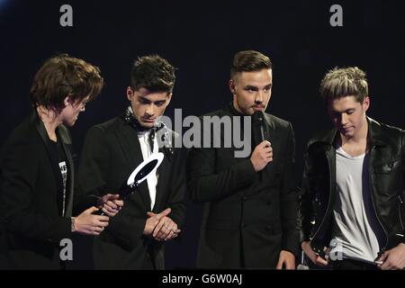 One Direction on stage with the award for Critics' Choice during the 2014 Brit Awards at the O2 Arena, London. Stock Photo