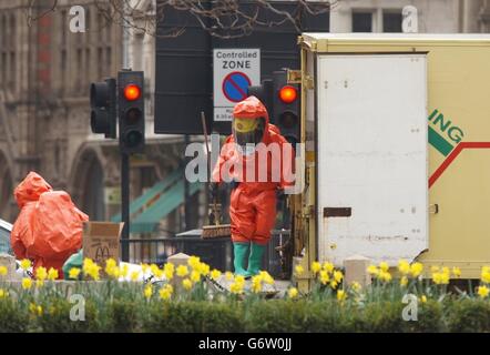 Firefighters in chemical protection suits in Parliament Square, London, following a clear up operation from a chemical spill from a lorry. Stock Photo