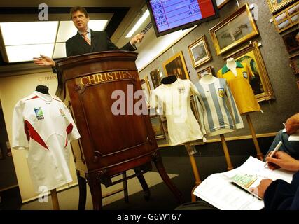 A battered England shirt worn by the late Bobby Moore (3rd right) fetches 59,750 in fooball and rugby memorabilia sale at Christie's in London. A Christie's spokesman said it was the most significant football shirt to come to auction since it sold Pele's 1970 World Cup Final shirt for 157,750 in March 2002 - setting a world record for a football shirt at auction. The shirt worn by Jason Leonard (left) during the 2003 Rugby World Cup did not reach its reserve price. Stock Photo