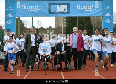 From left: Hugo Brasher, David Weir, Sir Roger Bannister and Diane Charles (nee Leather) pose with local children during a photocall at Paddington Recreation Ground, London. Stock Photo