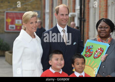 The Earl of Wessex, accompanied by his wife the Countess of Wessex (left), is presented with a 50th birthday card by pupils John Lieu, nine, (left) and Pharez Billy, seven, during a visit to Robert Browning Primary School in Walworth, London, to see the work of youth charity Kidscape, recipients of grants from the Wessex Youth Trust. Stock Photo