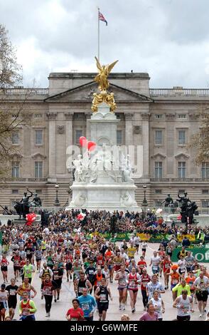 Runners near the end in the Flora London Marathon. Rain persisted for most of the morning as the competitors made their way across the capital past Tower Bridge and Canary Wharf and through the City of London. Stock Photo