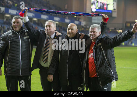 Rangers coaching staff (left to right) Jim Stewart, Ally McCoist, Kenny McDowall and Ian Durrant as they celebrate becoming Scottish League One Champions following their 3-0 win over Airdrieonians following the Scottish League One match at Ibrox, Glasgow. Stock Photo