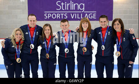 Great Britain's (left-right) Anna Sloan, Michael Goodfellow, Vicki Adams, Greg Drummond ,Claire Hamilton, Scott Andrews and Eve Muirhead during a photocall with men and womans team-mates on their return to The Peak at Stirling Sports Village, Stirling. Stock Photo