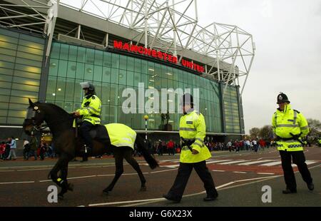 Police officers at Manchester United's Old Trafford ground where extra security checks were being carried for tonight's Manchester United match against Charlton following the anti-terrorism arrests of 10 people, the club confirmed. United decided to carry out an increased number of searches and warned all supporters to get to the ground as early as possible. Stock Photo