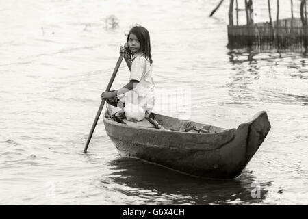 Young girl paddling dugout canoe, Peava village, Solomon Islands ...