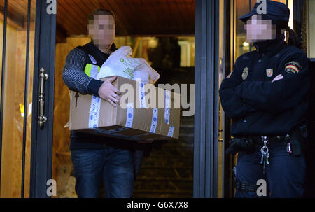 NOTE: IMAGE PIXELATED AT THE REQUEST OF THE POLICE Officers from City of London Police and their Spanish counterparts from the Policia Nacional remove items after raiding a business property in Barcelona, Spain, to execute a warrant in a joint operation as they target a boiler room investment fraud operation. Stock Photo